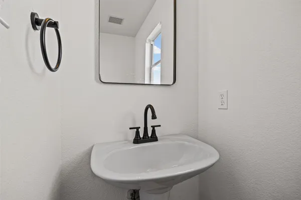 a bathroom with a sink and mirror