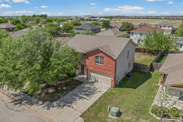 an aerial view of a house with a yard