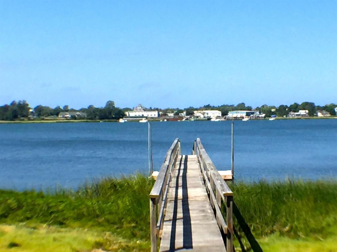 124 Tonset Road Orleans, MA 02653 - Photo 1 of 10 a view of a lake with a city view