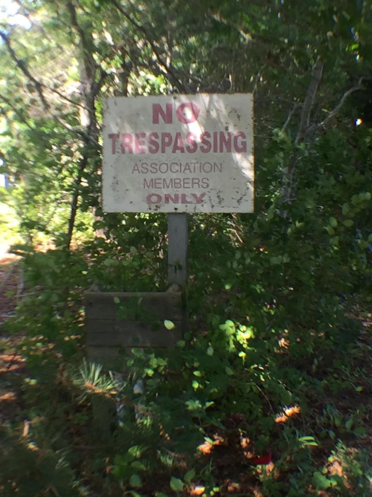 124 Tonset Road Orleans, MA 02653 - Photo 7 of 10 a sign that is sitting in a forest