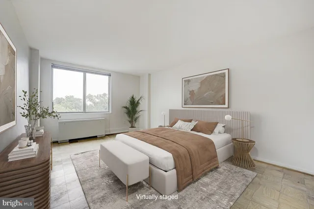 a bedroom with a bed wooden floor and window