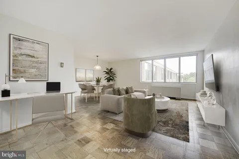 a living room with furniture and large windows