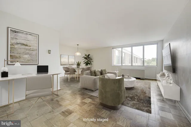 a living room with furniture and large windows