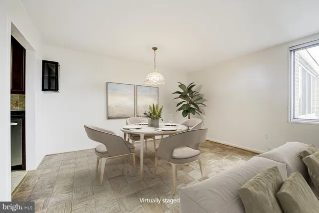 a living room with furniture a window and kitchen view