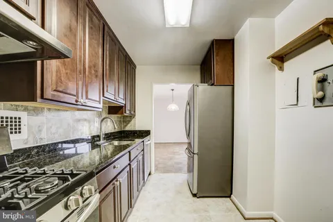 a kitchen with a refrigerator stove and sink
