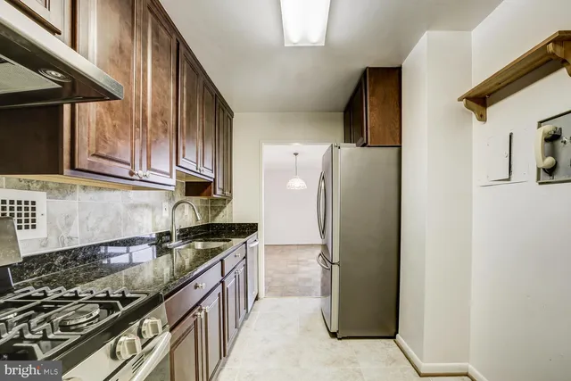a kitchen with a refrigerator stove and sink