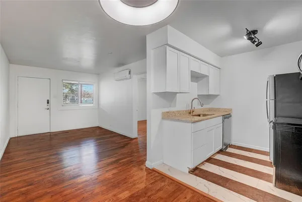 a kitchen with a refrigerator and a stove top oven