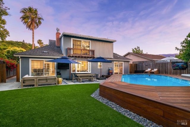 a front view of a house with a garden and patio