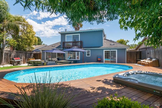 a front view of a house with swimming pool having outdoor seating