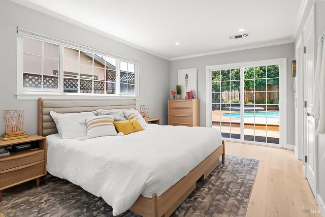 a bedroom with a large bed and a large window