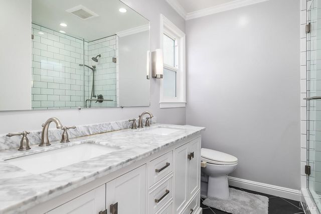 a bathroom with a granite countertop sink a toilet and a mirror