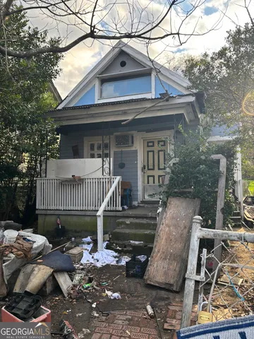 a view of a house with a roof deck and furniture