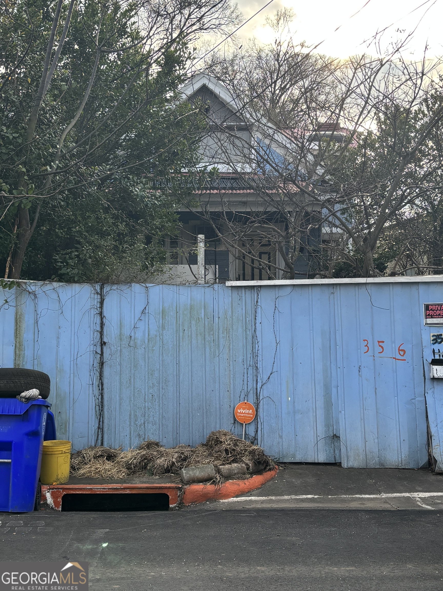 356 Stratton Street Macon, GA 31201 - Photo 2 of 3 a car parked in front of a wooden house