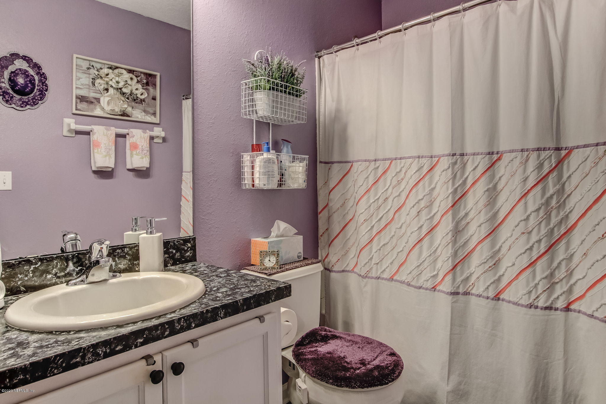 4816 Playschool Drive Jacksonville, FL 32210 - Photo 15 of 49 a bathroom with a sink and a mirror