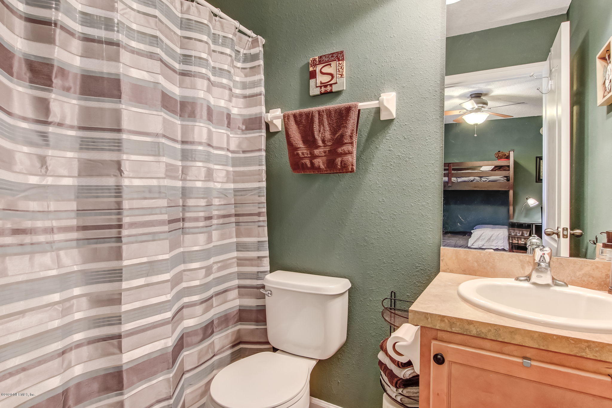4816 Playschool Drive Jacksonville, FL 32210 - Photo 18 of 49 a bathroom with a sink a toilet and a mirror