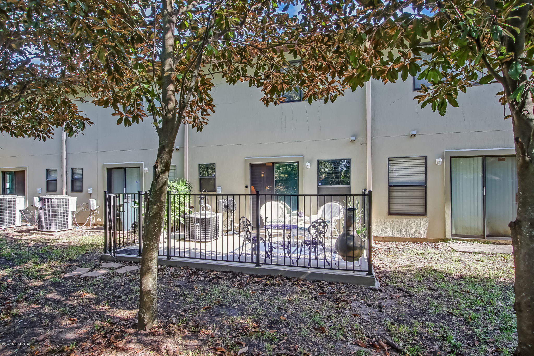 4816 Playschool Drive Jacksonville, FL 32210 - Photo 21 of 49 a view of a house with a tree and wooden fence