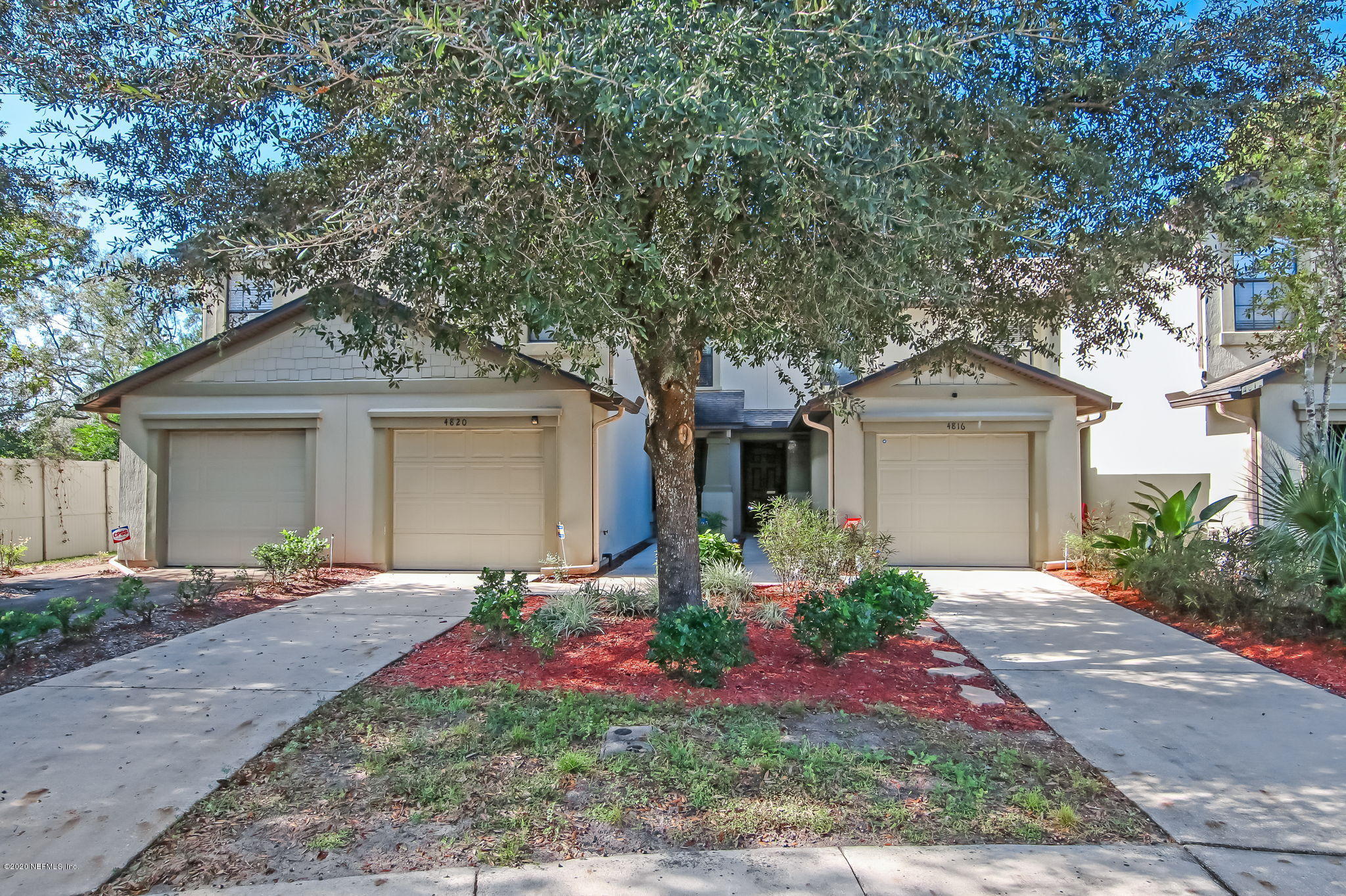 4816 Playschool Drive Jacksonville, FL 32210 - Photo 26 of 49 a front view of a house with a yard and potted plants