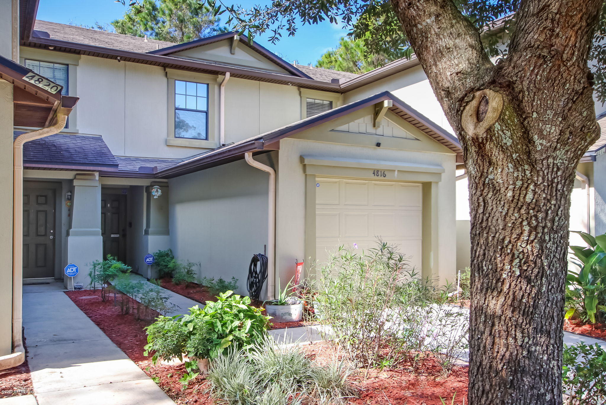 4816 Playschool Drive Jacksonville, FL 32210 - Photo 27 of 49 a front view of a house with garden