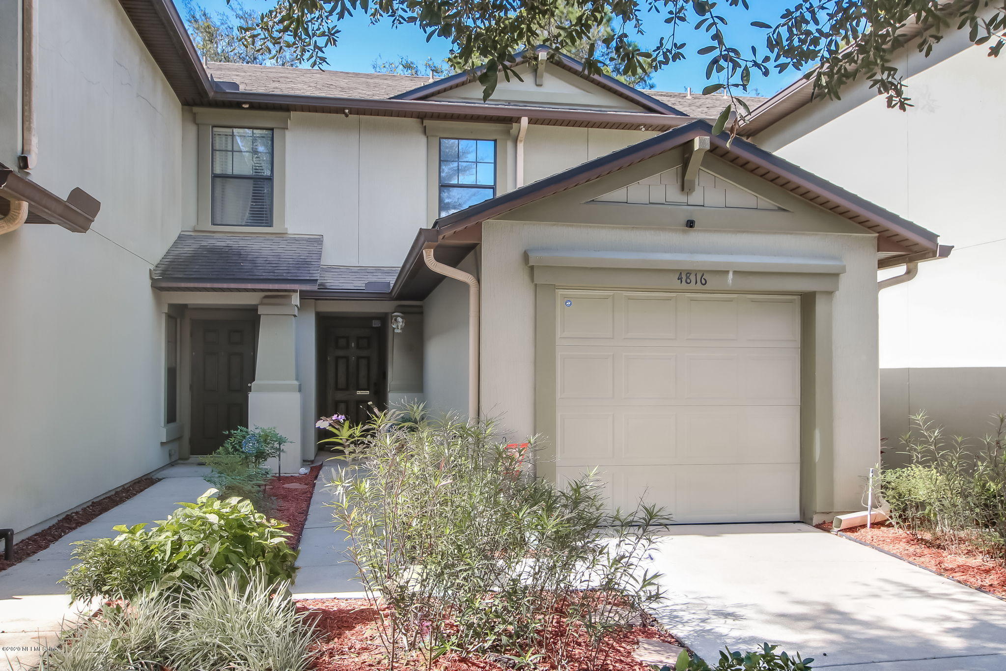 4816 Playschool Drive Jacksonville, FL 32210 - Photo 29 of 49 a front view of a house with garden