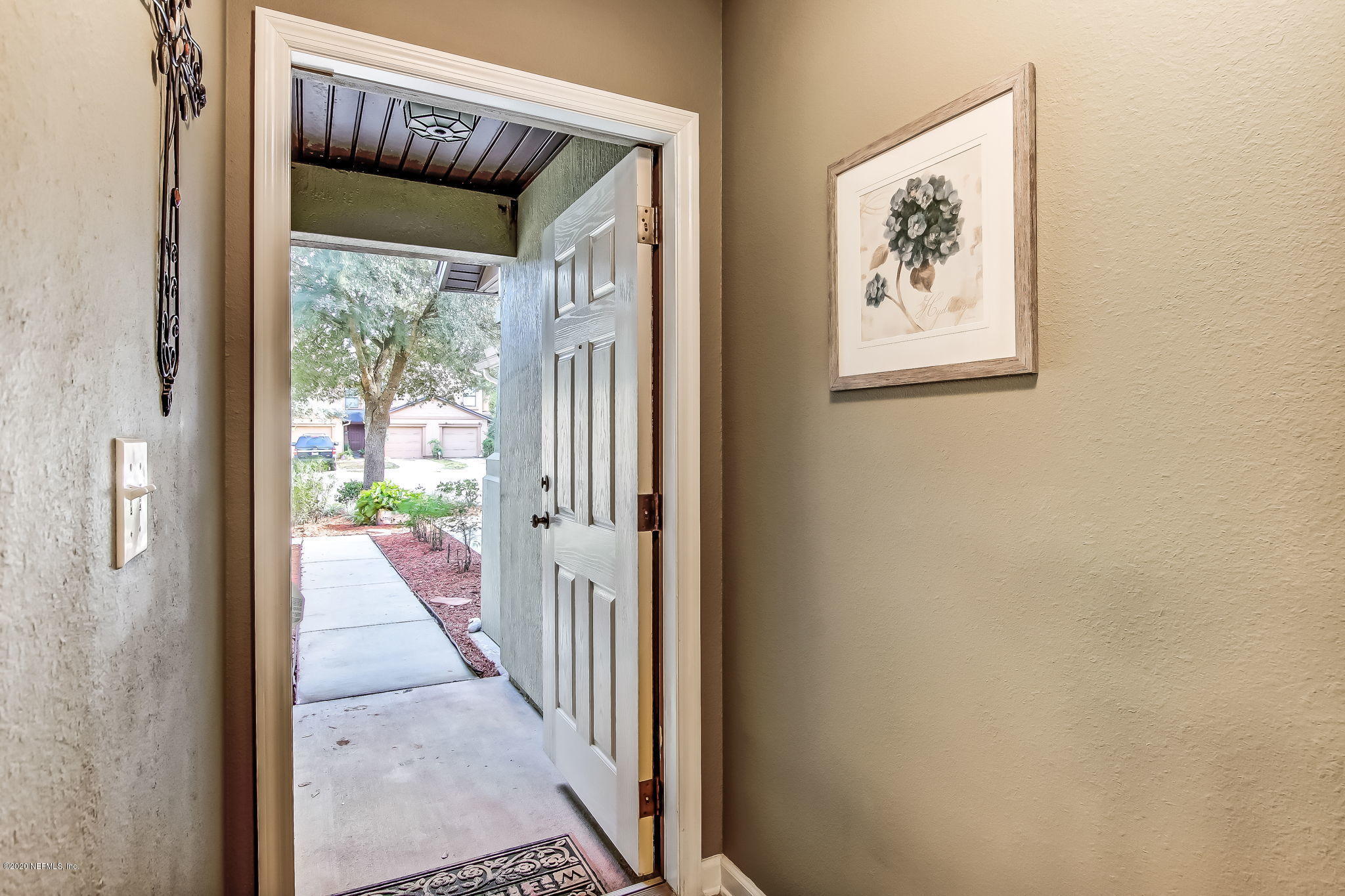 4816 Playschool Drive Jacksonville, FL 32210 - Photo 30 of 49 a view of a hallway with wooden floor and windows