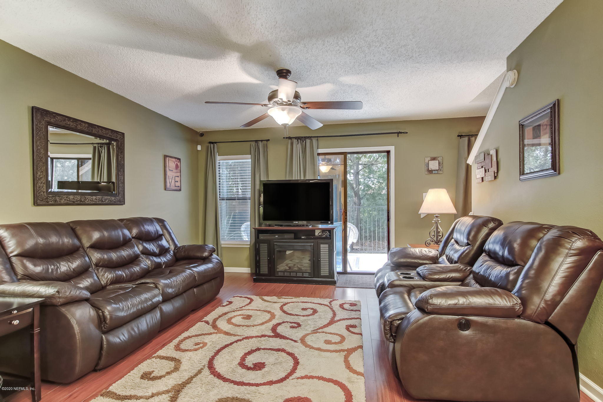 4816 Playschool Drive Jacksonville, FL 32210 - Photo 32 of 49 a living room with furniture and a flat screen tv