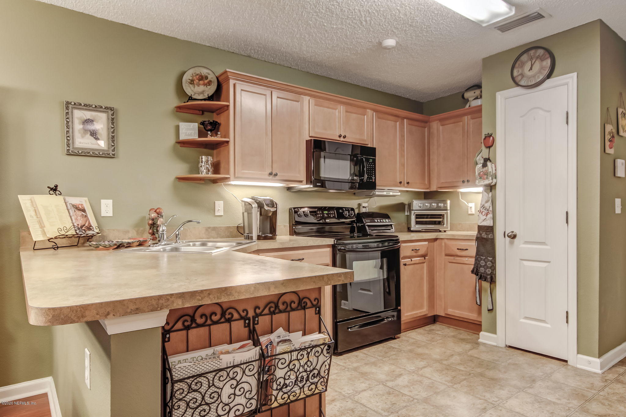 4816 Playschool Drive Jacksonville, FL 32210 - Photo 35 of 49 a kitchen with stainless steel appliances granite countertop a stove a sink and a refrigerator