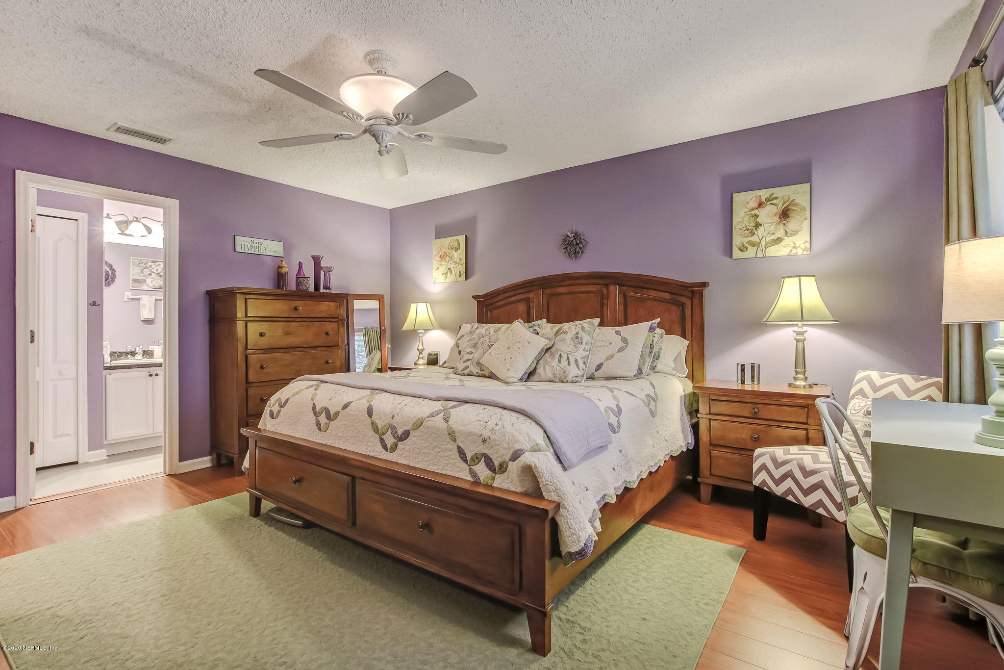 4816 Playschool Drive Jacksonville, FL 32210 - Photo 37 of 49 a bedroom with a bed and a table with closet