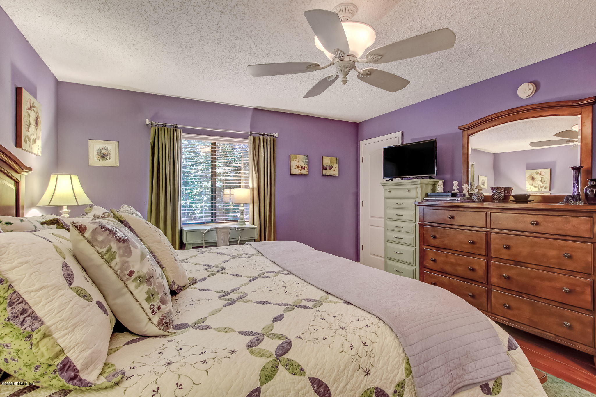 4816 Playschool Drive Jacksonville, FL 32210 - Photo 38 of 49 a bedroom with a bed and a dresser with television