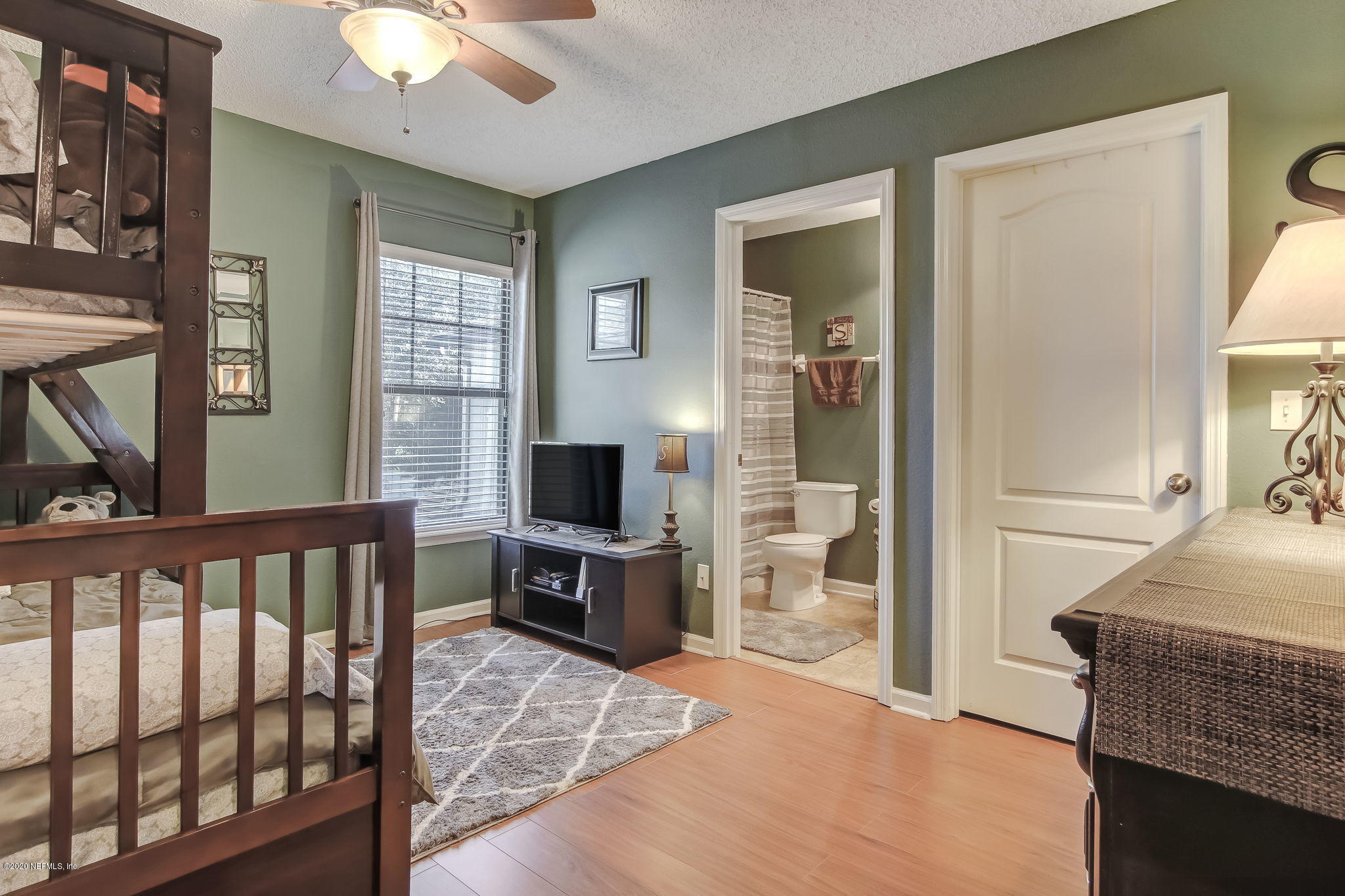 4816 Playschool Drive Jacksonville, FL 32210 - Photo 39 of 49 a bedroom with furniture and a flat screen tv