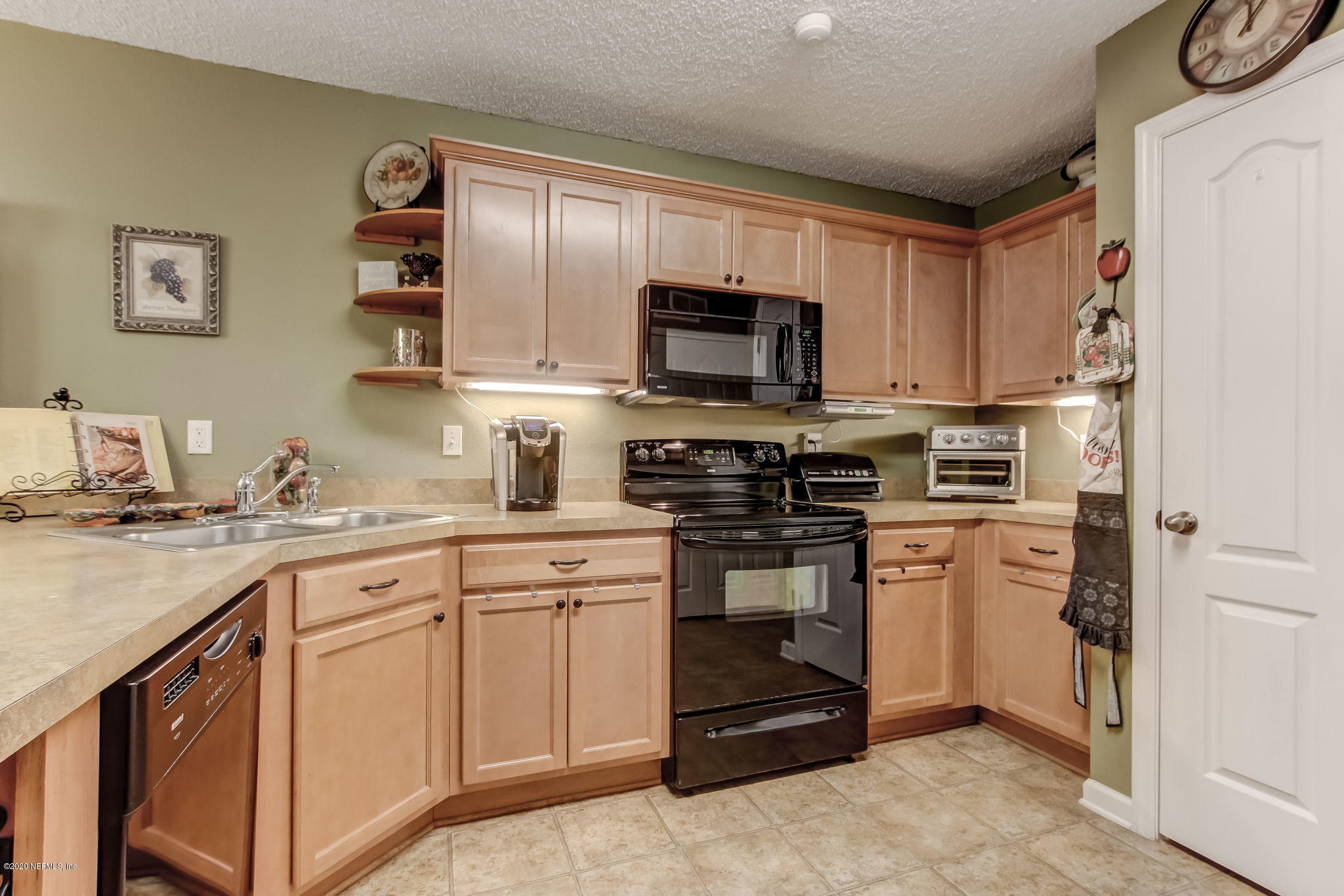 4816 Playschool Drive Jacksonville, FL 32210 - Photo 8 of 49 a kitchen with cabinets stainless steel appliances and a sink