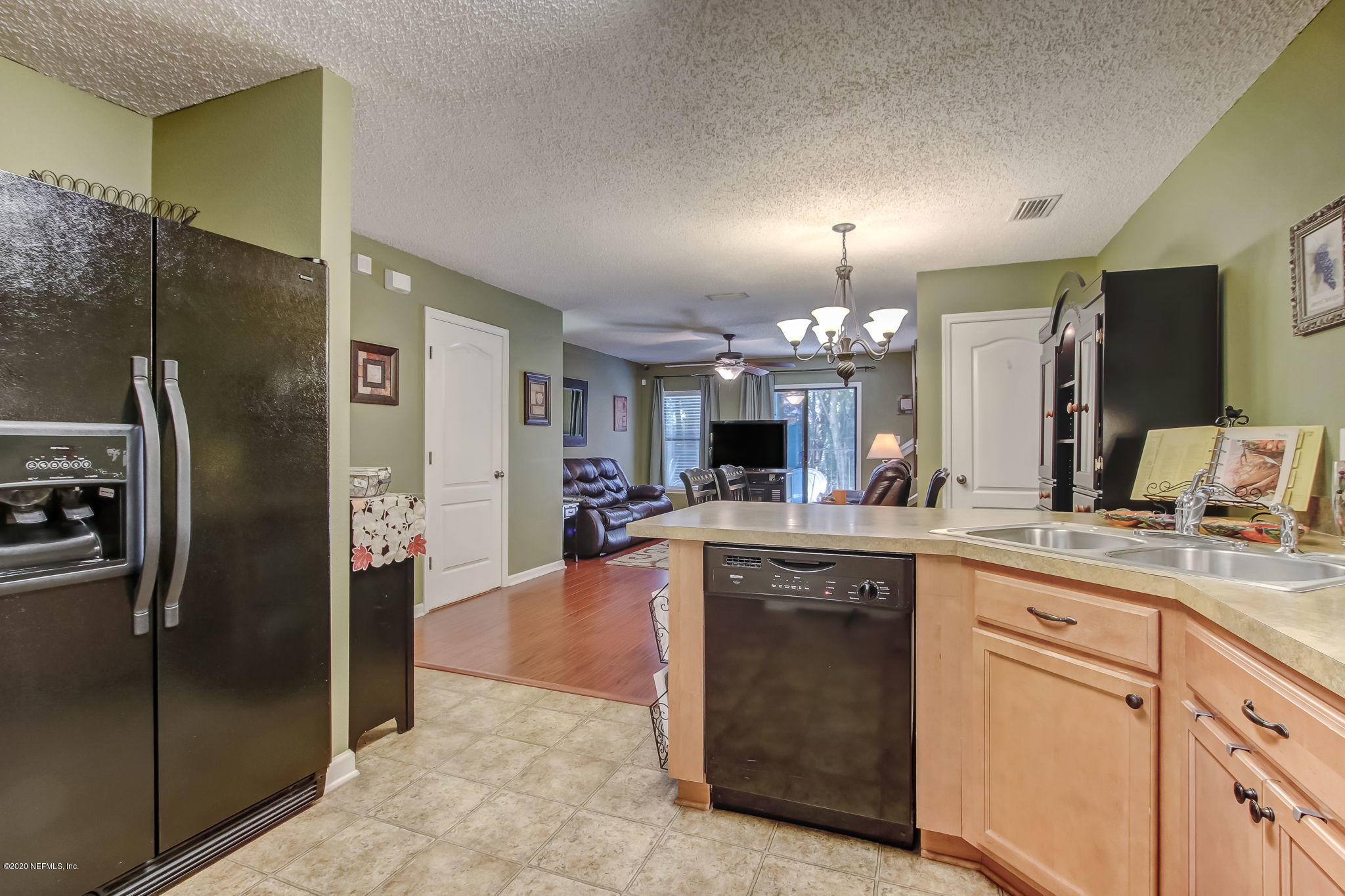 4816 Playschool Drive Jacksonville, FL 32210 - Photo 9 of 49 a kitchen with kitchen island a counter top space appliances and a sink