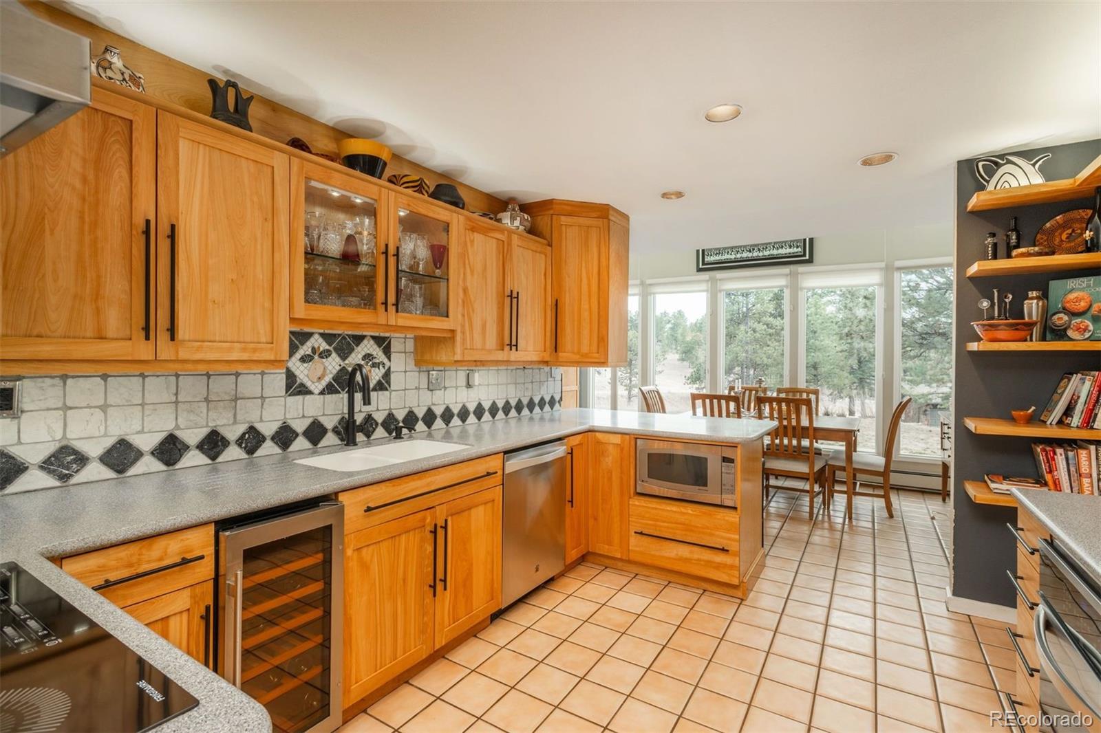 1551 Genesee Ridge Road Golden, CO 80401 - Photo 13 of 50 a kitchen with stainless steel appliances granite countertop a sink and cabinets