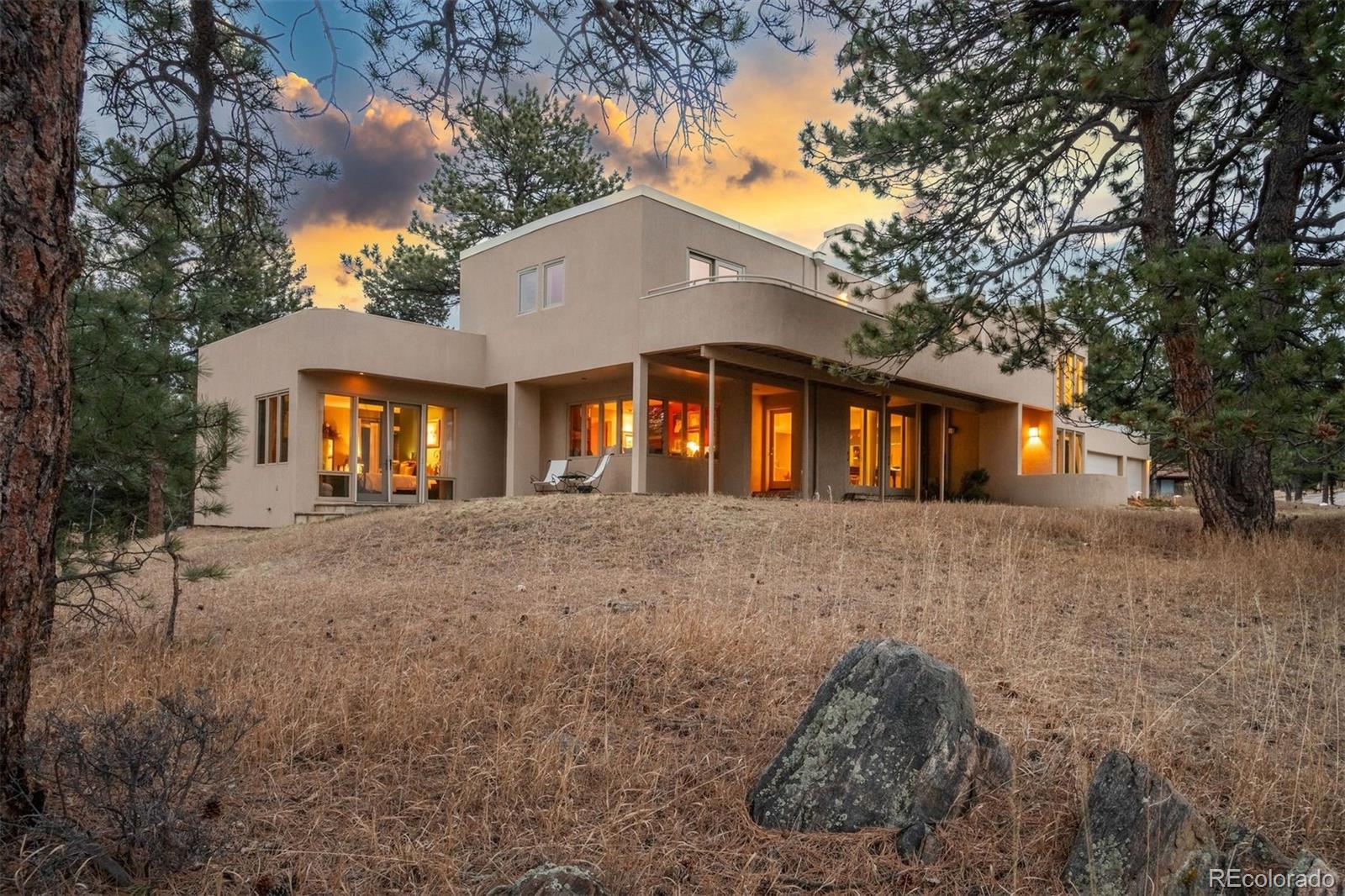 1551 Genesee Ridge Road Golden, CO 80401 - Photo 16 of 50 a front view of a house with a yard