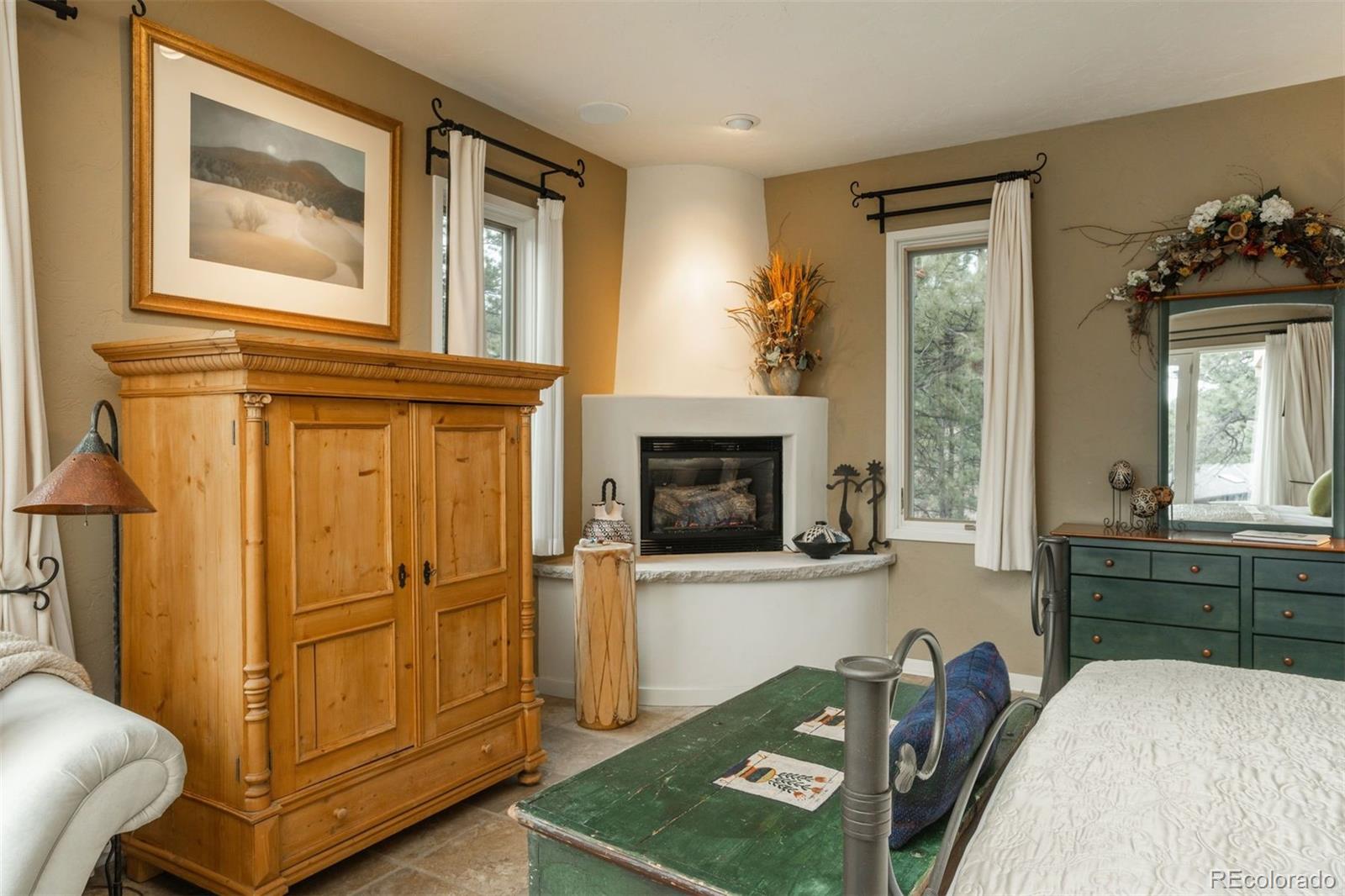 1551 Genesee Ridge Road Golden, CO 80401 - Photo 17 of 50 a living room with furniture wooden floor and a fireplace