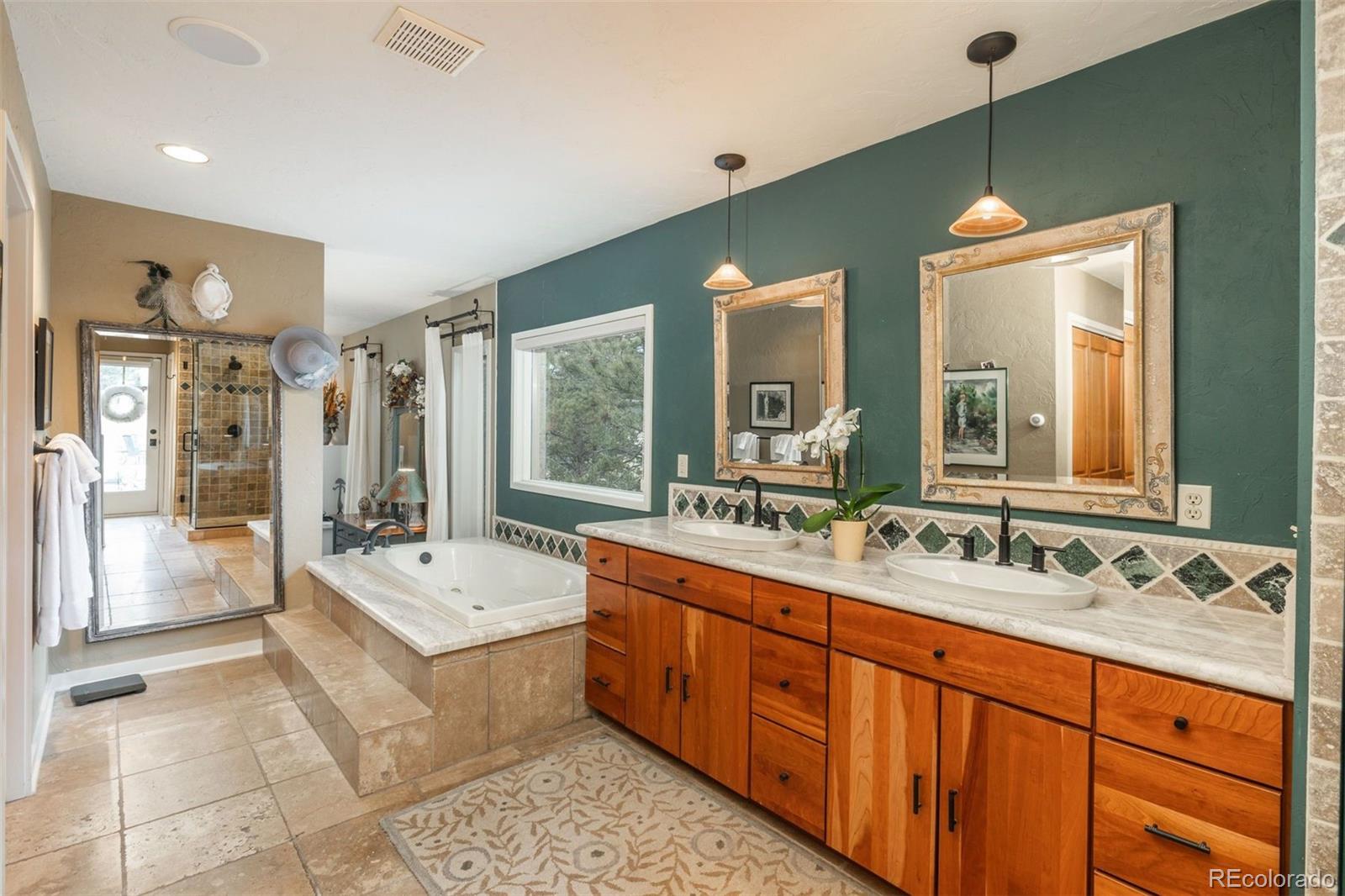 1551 Genesee Ridge Road Golden, CO 80401 - Photo 18 of 50 a bathroom with a double vanity sink mirror and bathtub