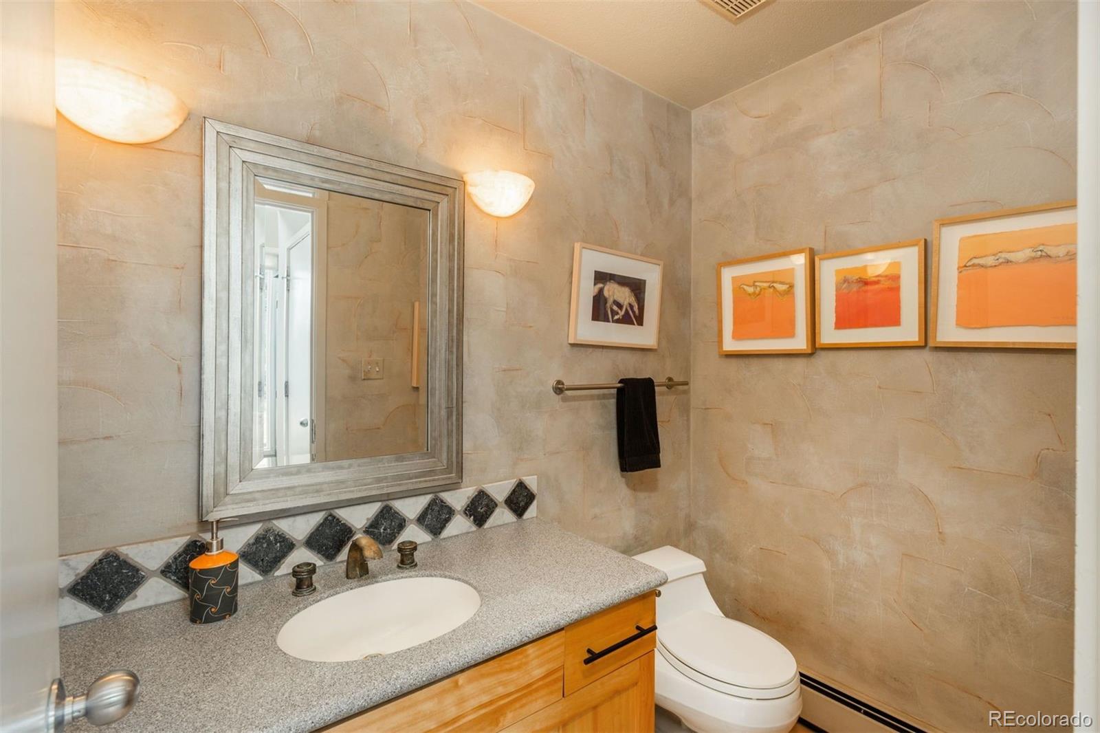 1551 Genesee Ridge Road Golden, CO 80401 - Photo 25 of 50 a bathroom with a sink toilet vanity and shower