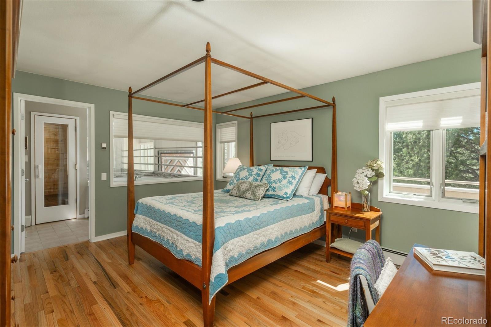 1551 Genesee Ridge Road Golden, CO 80401 - Photo 28 of 50 a bedroom with a bed and wooden floor