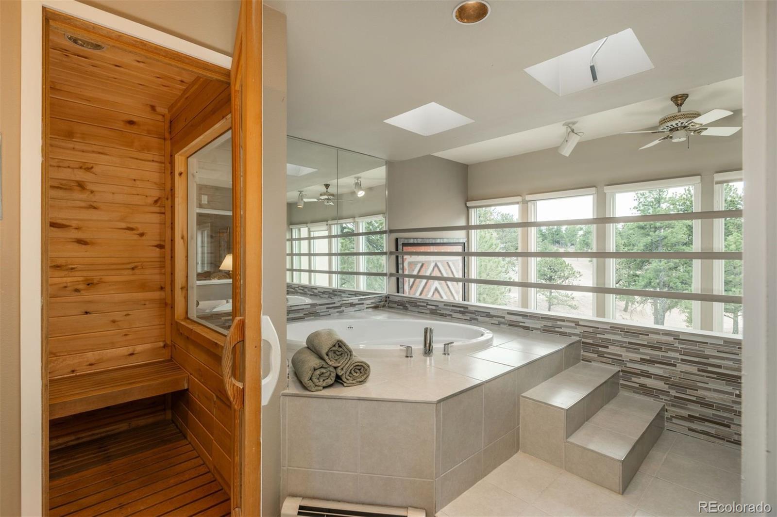 1551 Genesee Ridge Road Golden, CO 80401 - Photo 30 of 50 a bathroom with a tub a sink and a large window