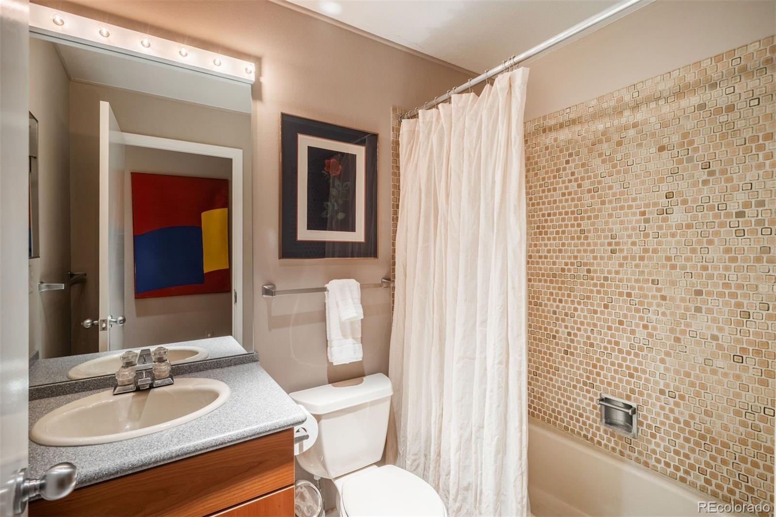 1551 Genesee Ridge Road Golden, CO 80401 - Photo 39 of 50 a bathroom with a sink toilet and shower