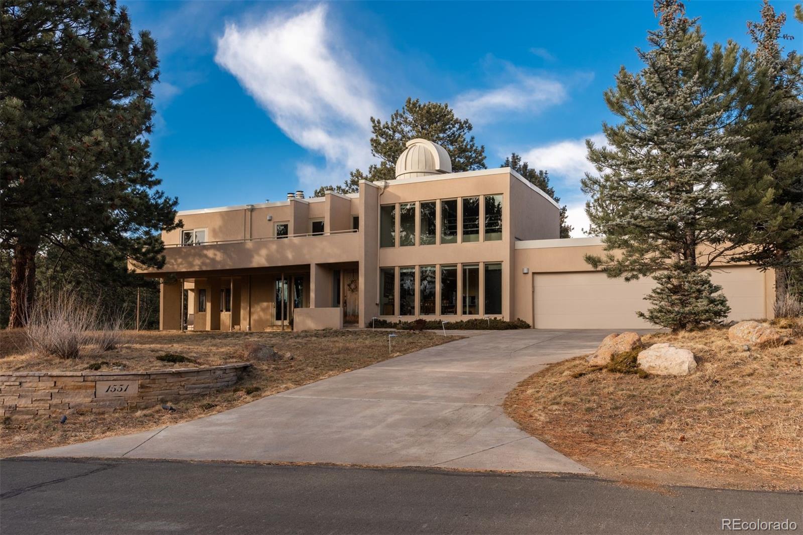 1551 Genesee Ridge Road Golden, CO 80401 - Photo 43 of 50 a front view of a building with a yard