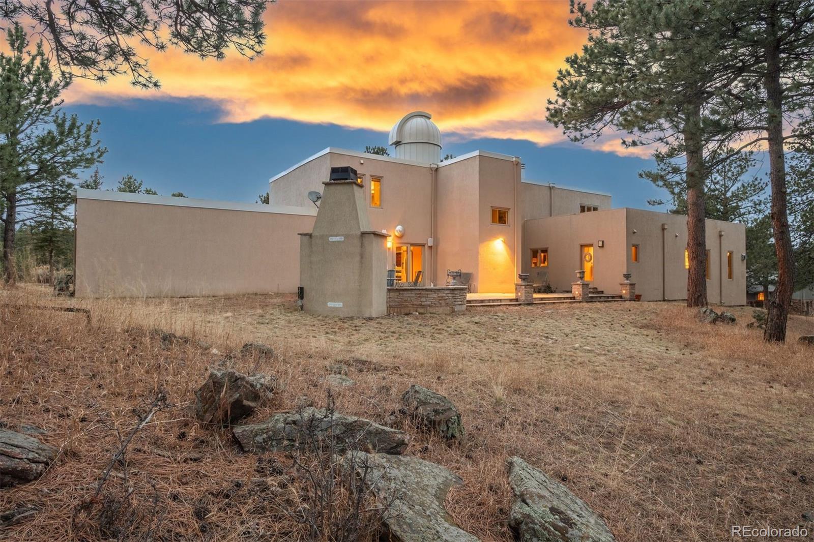 1551 Genesee Ridge Road Golden, CO 80401 - Photo 43 of 50 a view of a house with backyard and trees