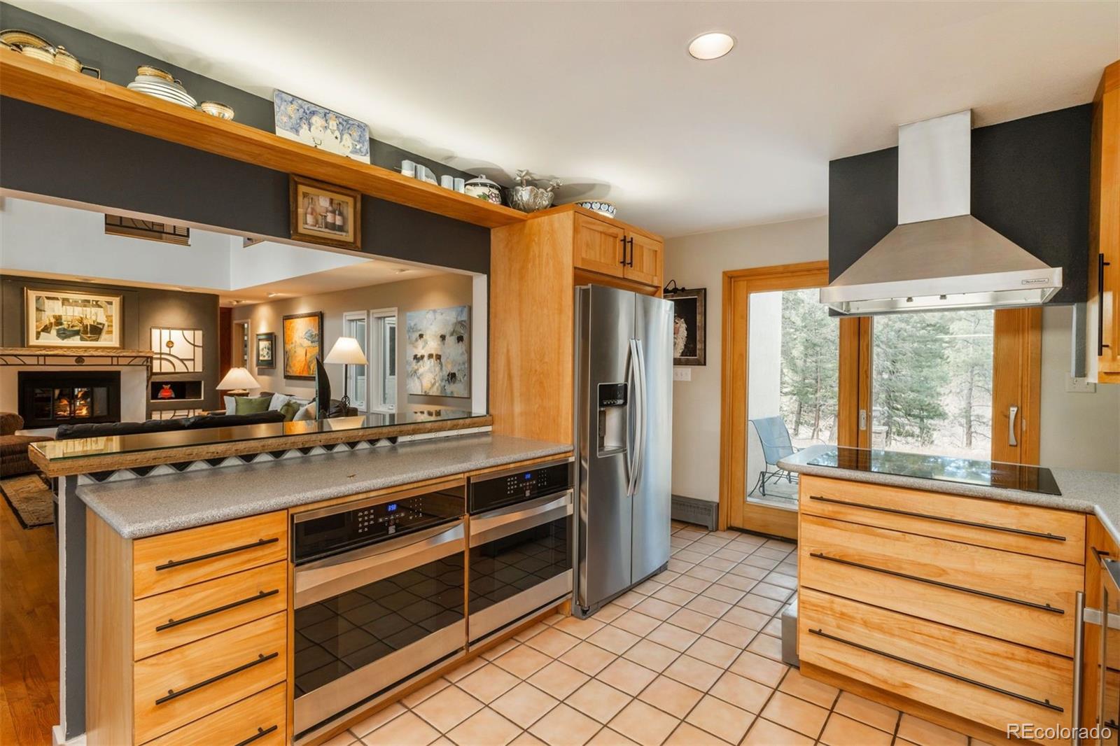 1551 Genesee Ridge Road Golden, CO 80401 - Photo 9 of 50 a kitchen with stainless steel appliances granite countertop a stove and a refrigerator