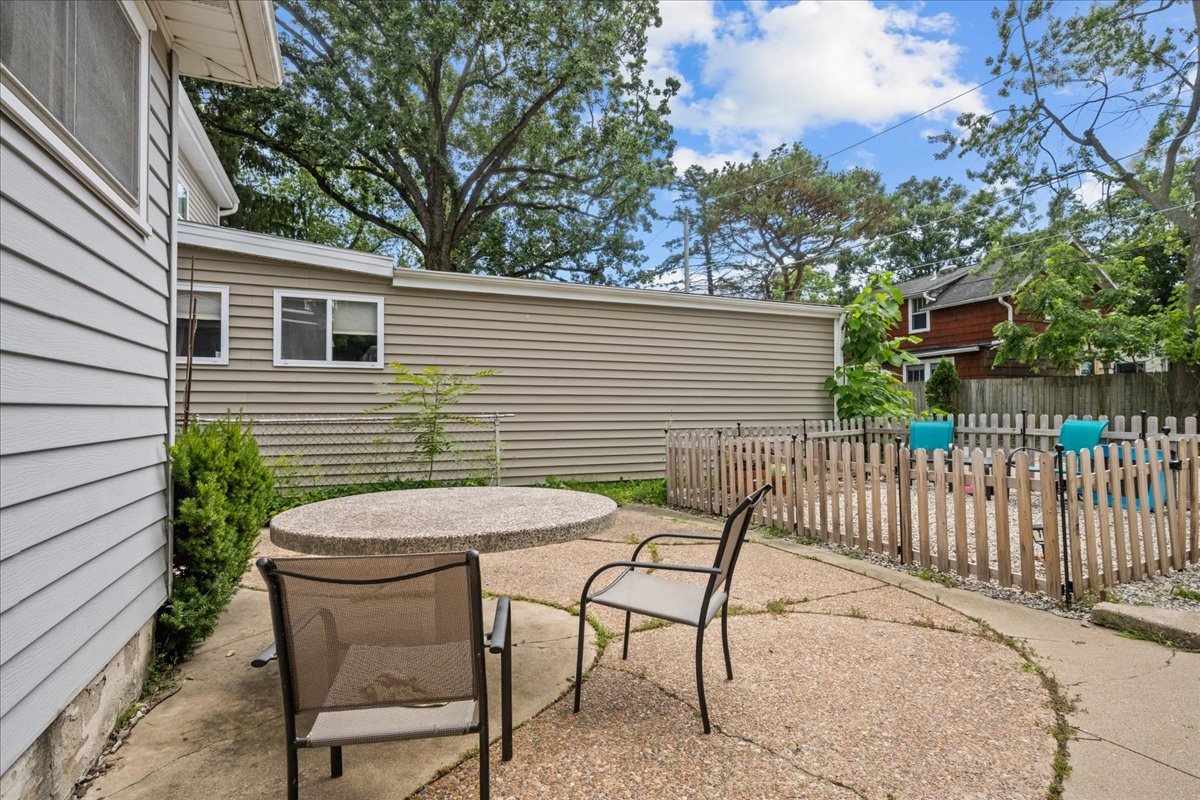 2490 Green Bay Road, Unit 1 Highland Park, IL 60035 - Photo 16 of 18 a backyard of a house with table and chairs