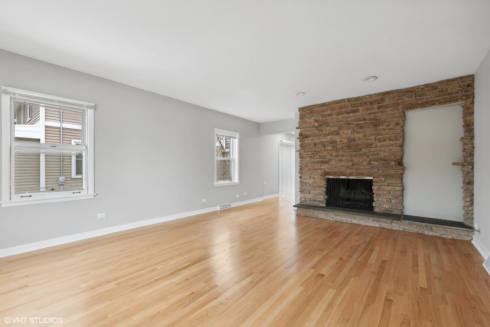 2490 Green Bay Road, Unit 1 Highland Park, IL 60035 - Photo 4 of 18 an empty room with wooden floor fireplace and windows