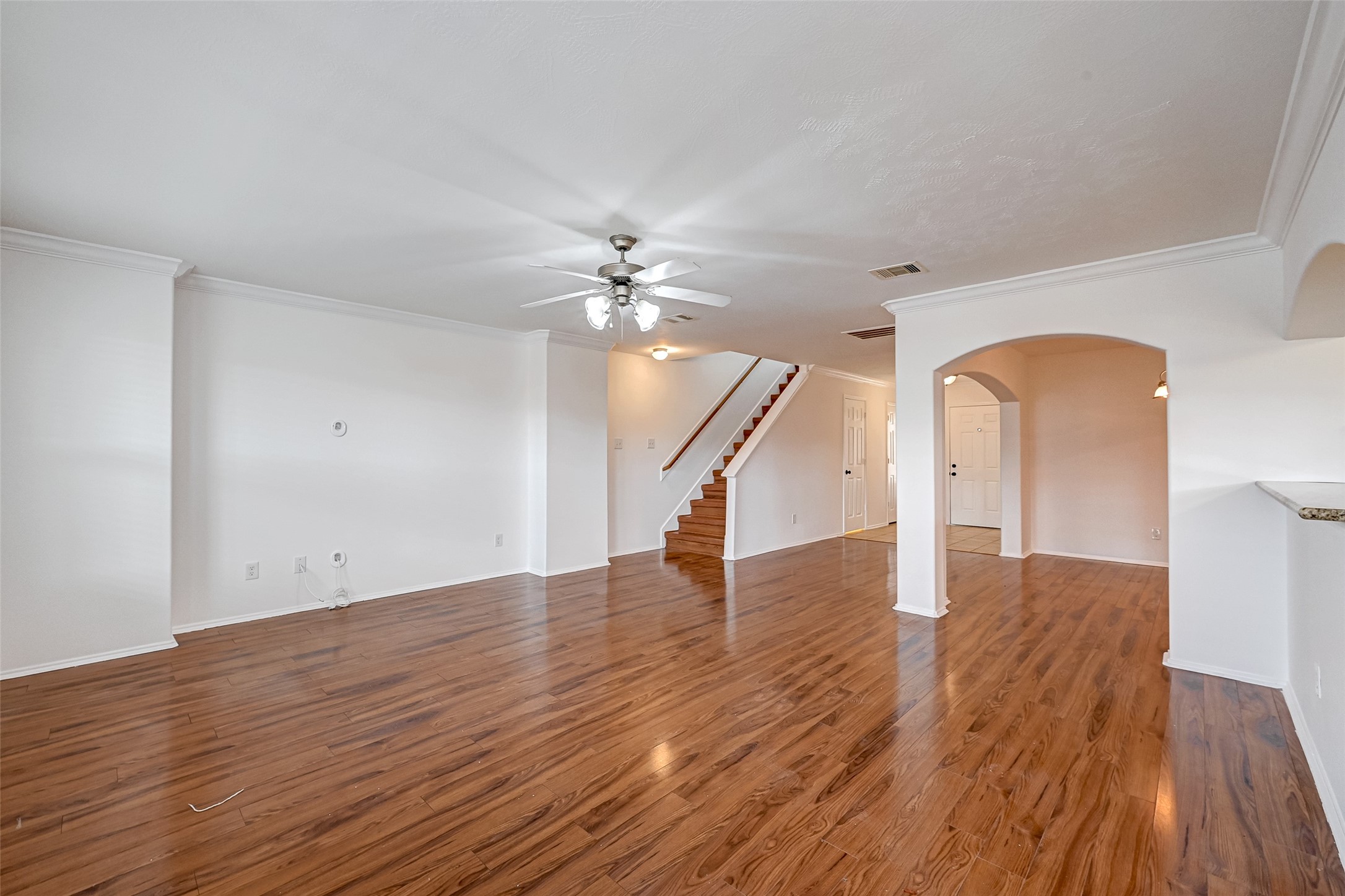 6906 Anson Point Lane Houston, TX 77040 - Photo 8 of 31 a view of an empty room with wooden floor and staircase