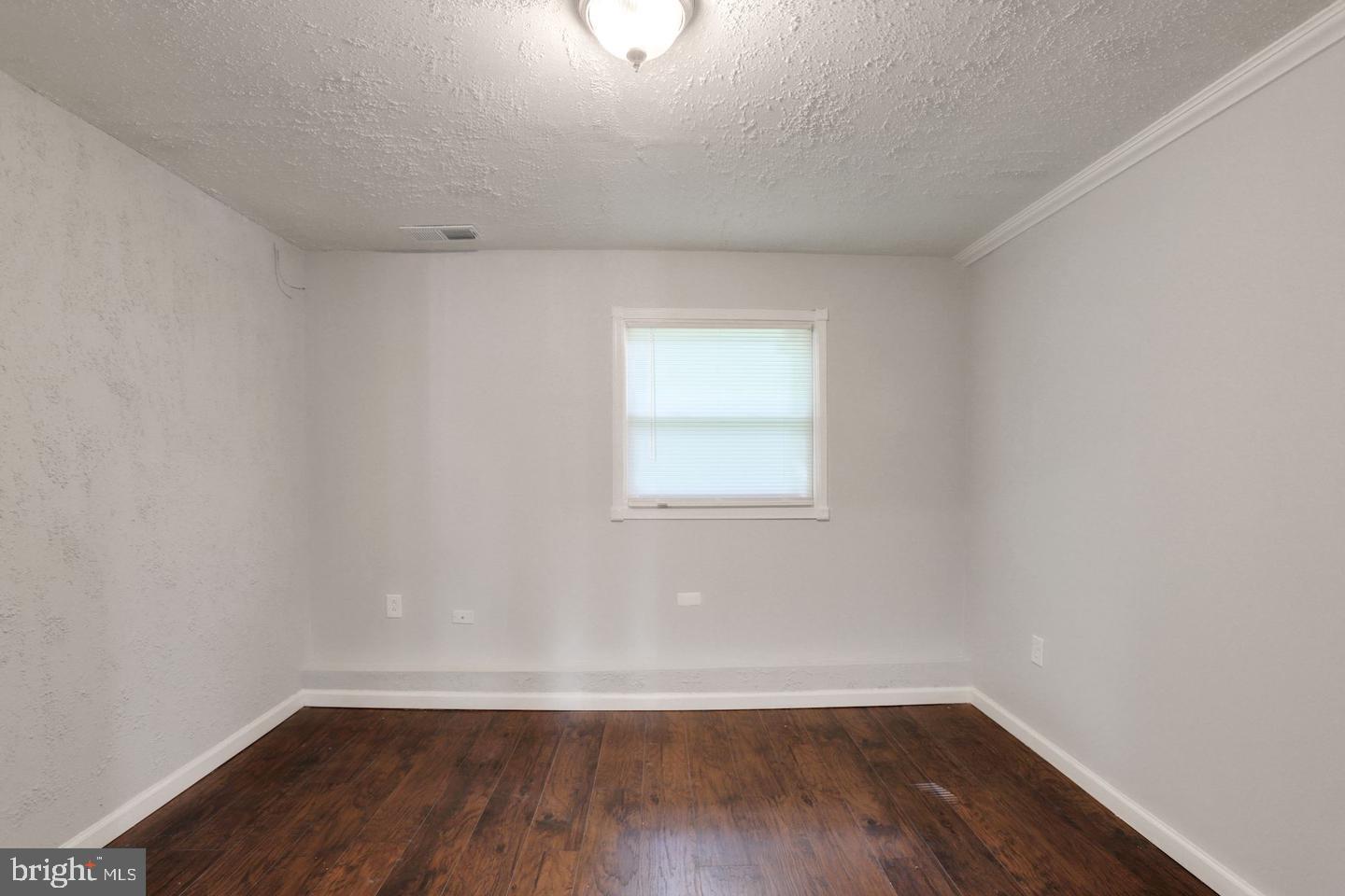 5504 Keppler Road Temple Hills, MD 20748 - Photo 16 of 19 a view of a room with wooden floor and window