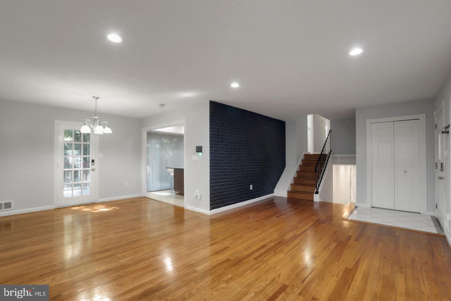 5504 Keppler Road Temple Hills, MD 20748 - Photo 3 of 19 a view of an empty room with wooden floor and a kitchen
