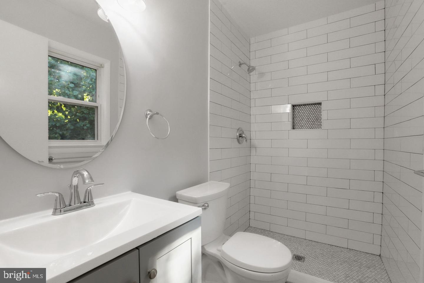 5504 Keppler Road Temple Hills, MD 20748 - Photo 7 of 19 a bathroom with a sink a toilet and a mirror