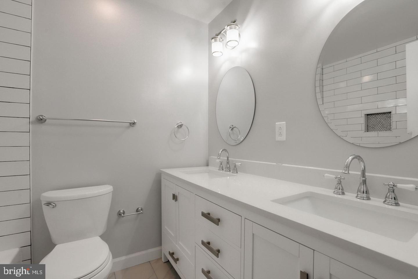 5504 Keppler Road Temple Hills, MD 20748 - Photo 9 of 19 a bathroom with a toilet a sink and mirror