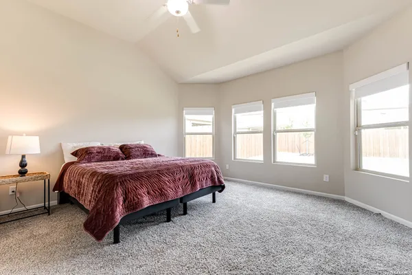 a spacious bedroom with a bed and a window